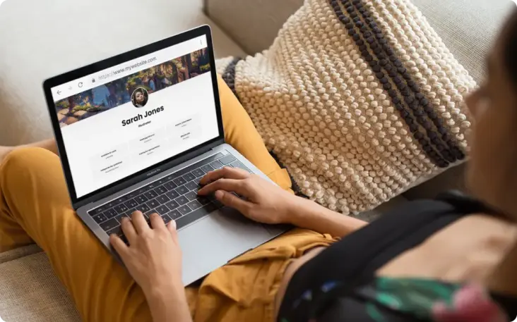 Woman holding laptop with author page on-screen